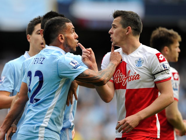 Manchester City's Carlos Tevez and Queens Park Rangers' Joey Barton clash on May 13, 2012