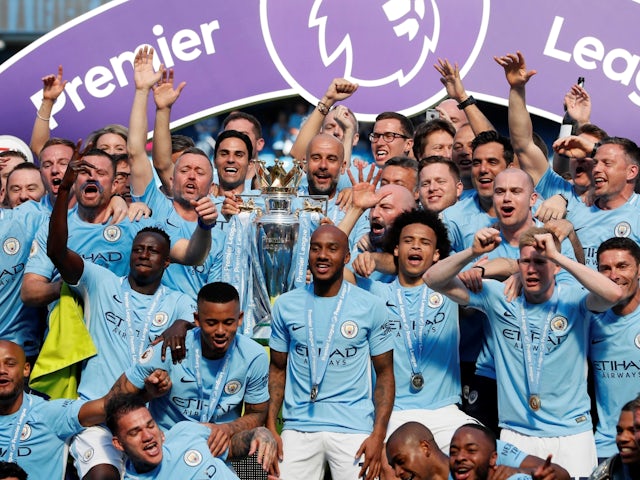 Pep Guardiola and his Manchester City players celebrate with the Premier League trophy on May 6, 2018