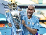 Manchester City manager Pep Guardiola celebrates with the Premier League trophy on May 19, 2024