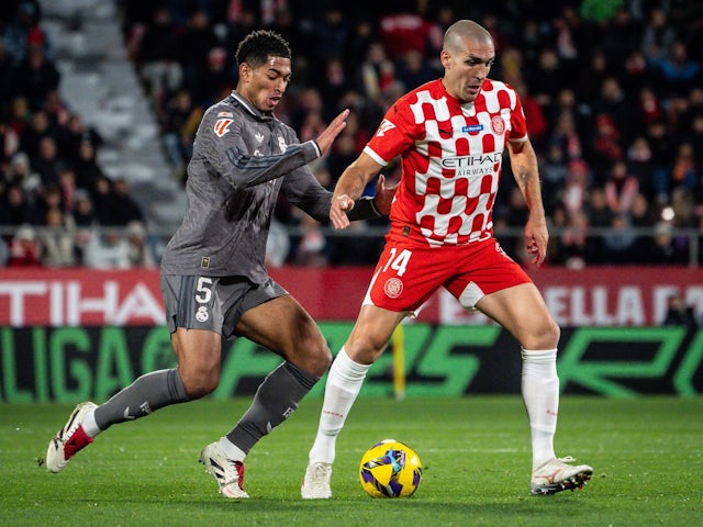 Real Madrid's Jude Bellingham in action with Girona's Oriol Romeu on December 7, 2024