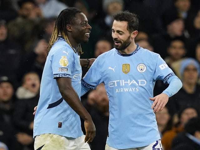 Manchester City's Jeremy Doku celebrates scoring with Bernardo Silva on December 4, 2024