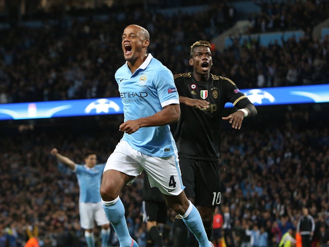 Juventus' Paul Pogba looks on as Manchester City's Vincent Kompany celebrates on September 15, 2015