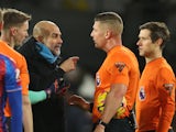 Manchester City manager Pep Guardiola remonstrates with referee Rob Jones on December 7, 2024