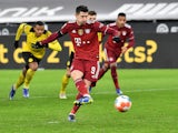 Bayern Munich's Robert Lewandowski scores the winning goal against Borussia Dortmund on December 4, 2021