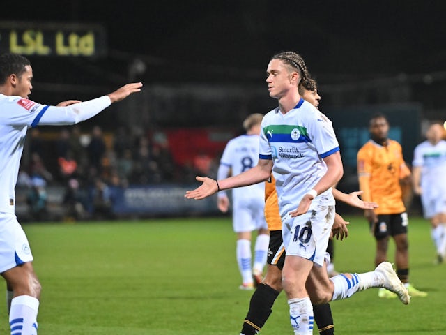 Thelo Aasgaard of Wigan Athletic celebrates scoring against Cambridge United on November 30, 2024