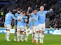 Erling Haaland celebrates with his Manchester City teammates after scoring on December 29, 2024