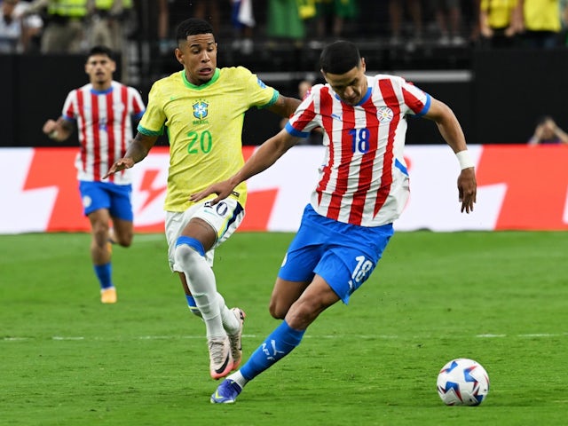 Savio of Brazil fights for the ball with Alex Arce of Paraguay on June 28, 2024