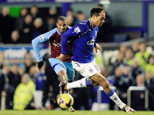 Aston Villa's Ashley Young dribbles past Everton's Joleon Lescott on December 7, 2008