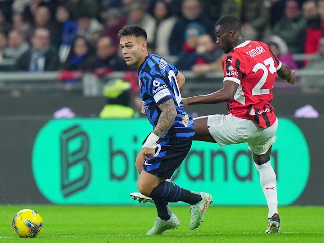 Inter Milan's Lautaro Martinez fights for the ball with AC Milan's Fikayo Timori during their sides' Serie A clash, on February 2, 2025