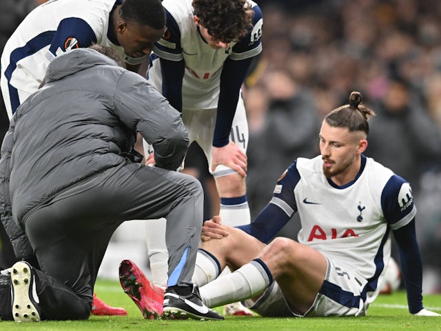 Tottenham Hotspur's Radu Dragusin receives treatment for an injury on January 30, 2025