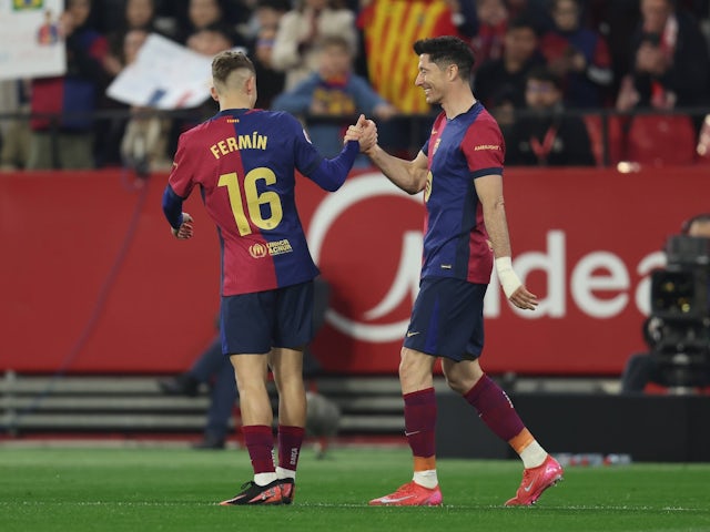 Barcelona's Fermin Lopez and Robert Lewandowski celebrate a goal against Sevilla on February 9, 2025