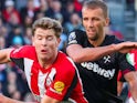 Nathan Collins of Brentford is put under pressure by Tomas Soucek of West Ham United on September 28, 2024