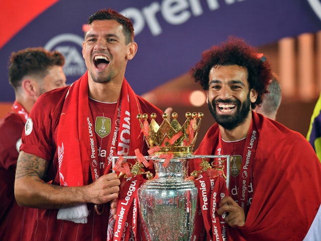 Liverpool's Dejan Lovren and Mohamed Salah celebrate with the Premier League trophy on July 22, 2020