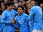 Manchester City's Omar Marmoush celebrates with Abdukodir Khusanov and Erling Haaland on February 15, 2025