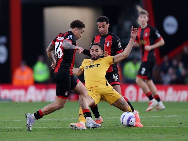 Wolverhampton Wanderers' Matheus Cunha (centre) is tackled by Bournemouth's Tyler Adams and Marcus Tavernier (left) on February 22, 2025